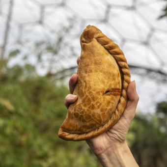 Hand holding Cornish pasty at Eden Project